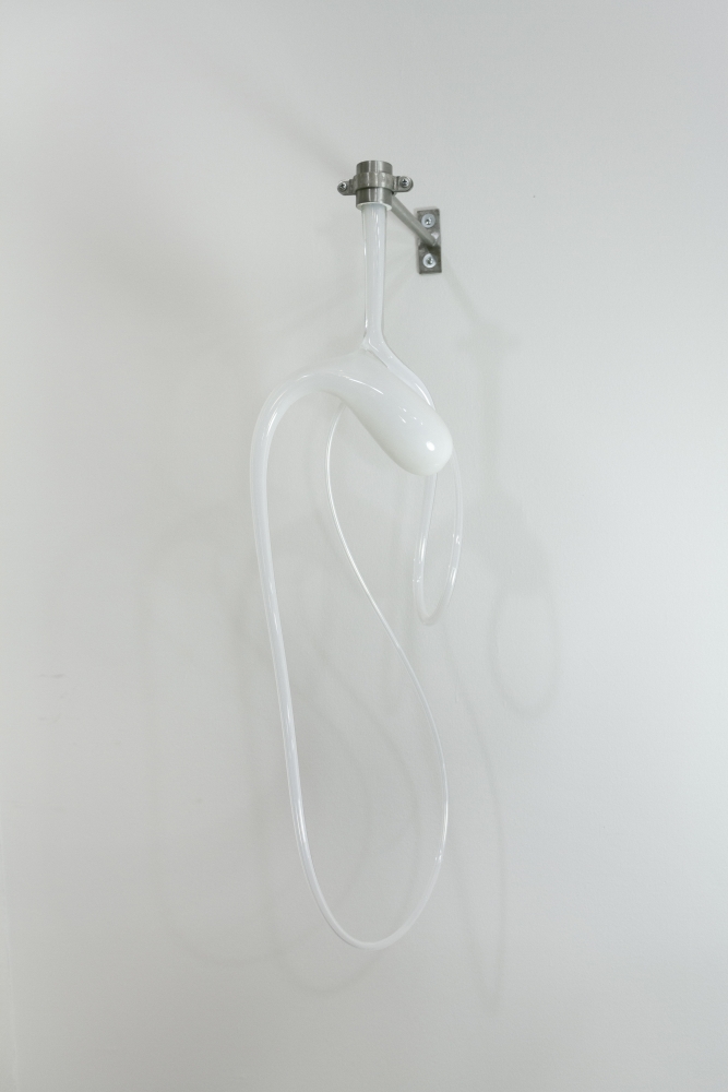 Opaque white glass sculpture by Ivana Bašić hanging in an elliptical shape from a stainless steel rod.
