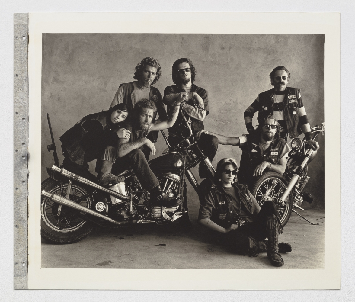 Black and white group photograph of motorcyclists.