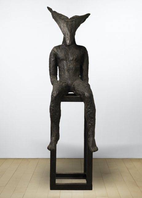 Bronze sculpture by Magdalena Abakanowicz of a seated figure with an angular head on a pedestal