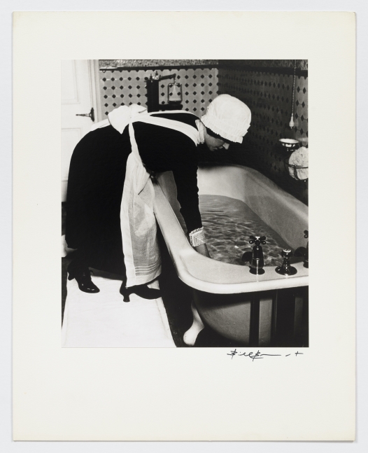 Black and white photographic portrait of parlormaid preparing a bath from the 1930s by Bill Brandt.