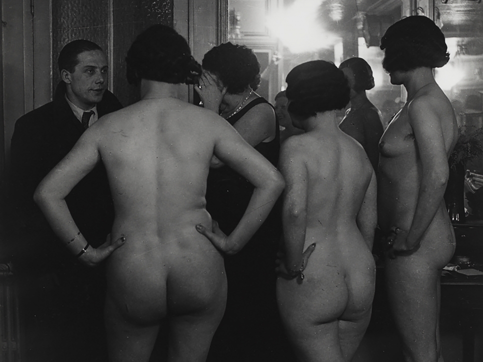 Black and white photography by Brassaï featuring the behind view of nude women standing