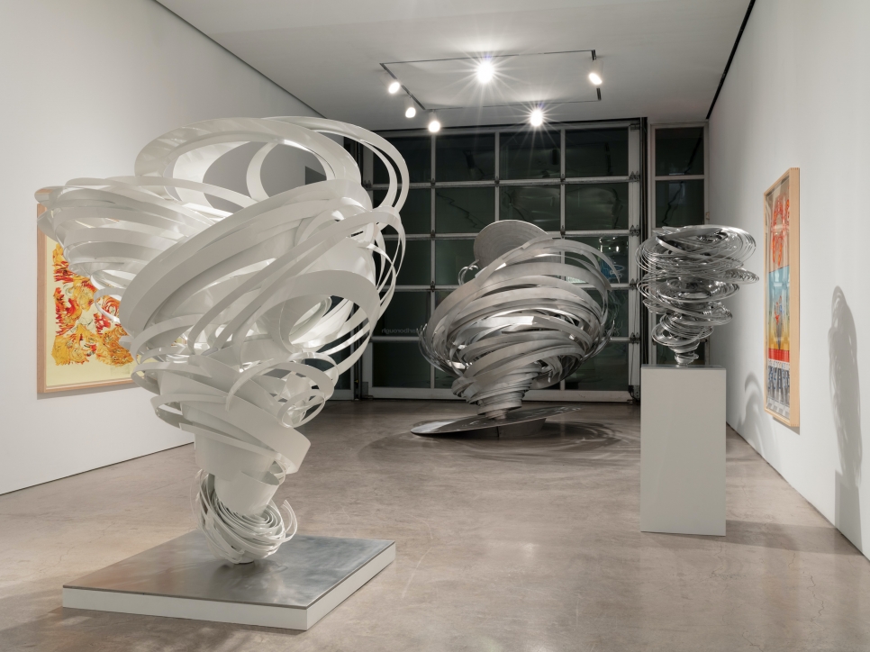 Installation view featuring twisted aluminum sculptures and drawings by Alice Aycock