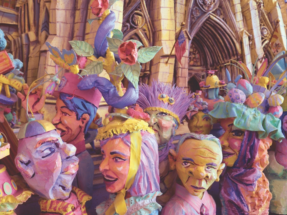 Detail of work by Red Grooms featuring a colorful oil painting on canvas of a crowd of figures smiling and socializing. Featuring a massive smiling mouth at the top center of the piece with a person laying horizontal below it.